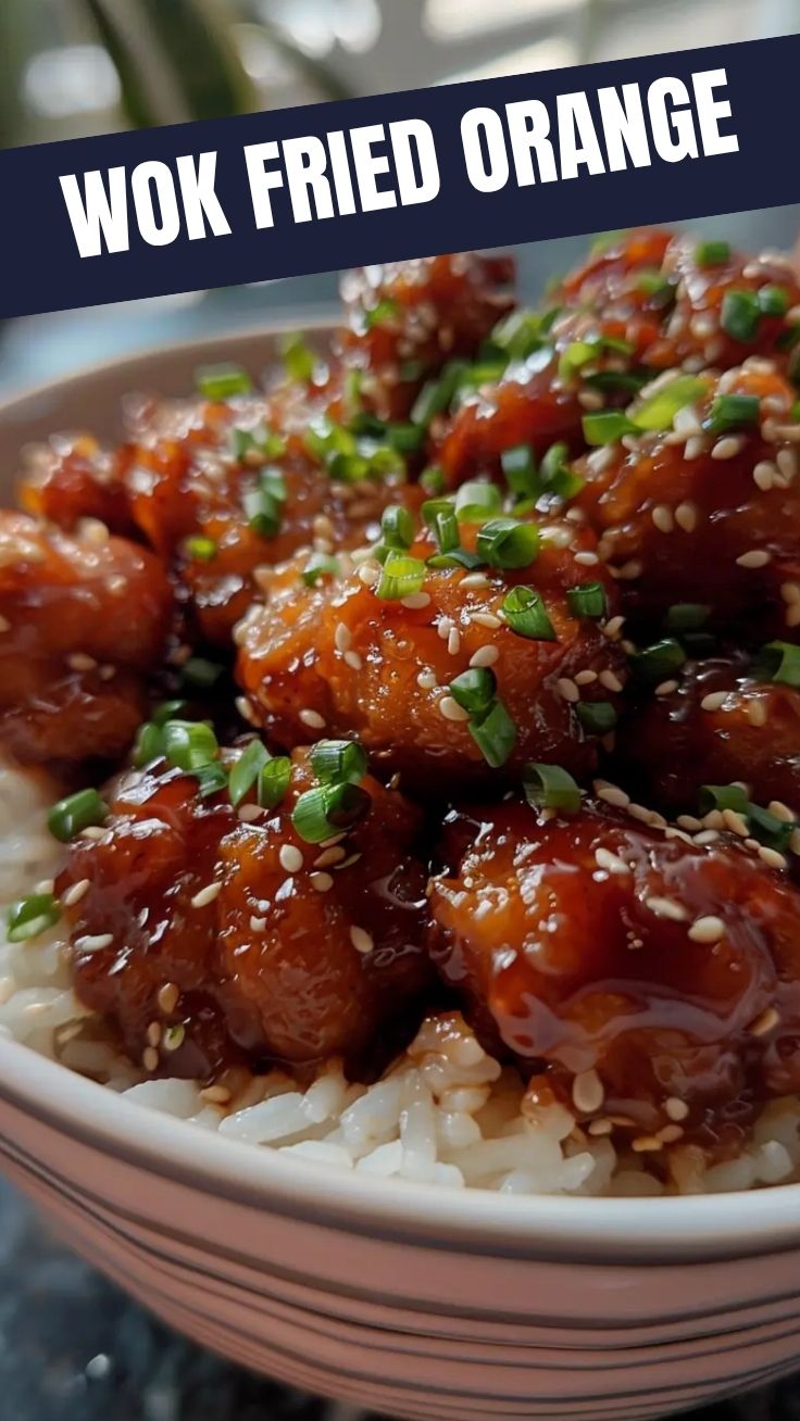 A plate full of crispy Orange Chicken (Panda Express Style) with a glossy sauce.