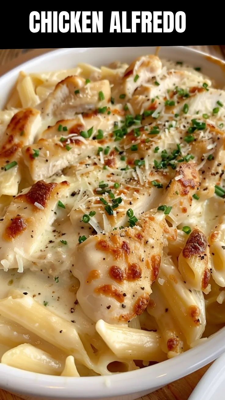 A serving of creamy chicken Alfredo pasta on a white plate.