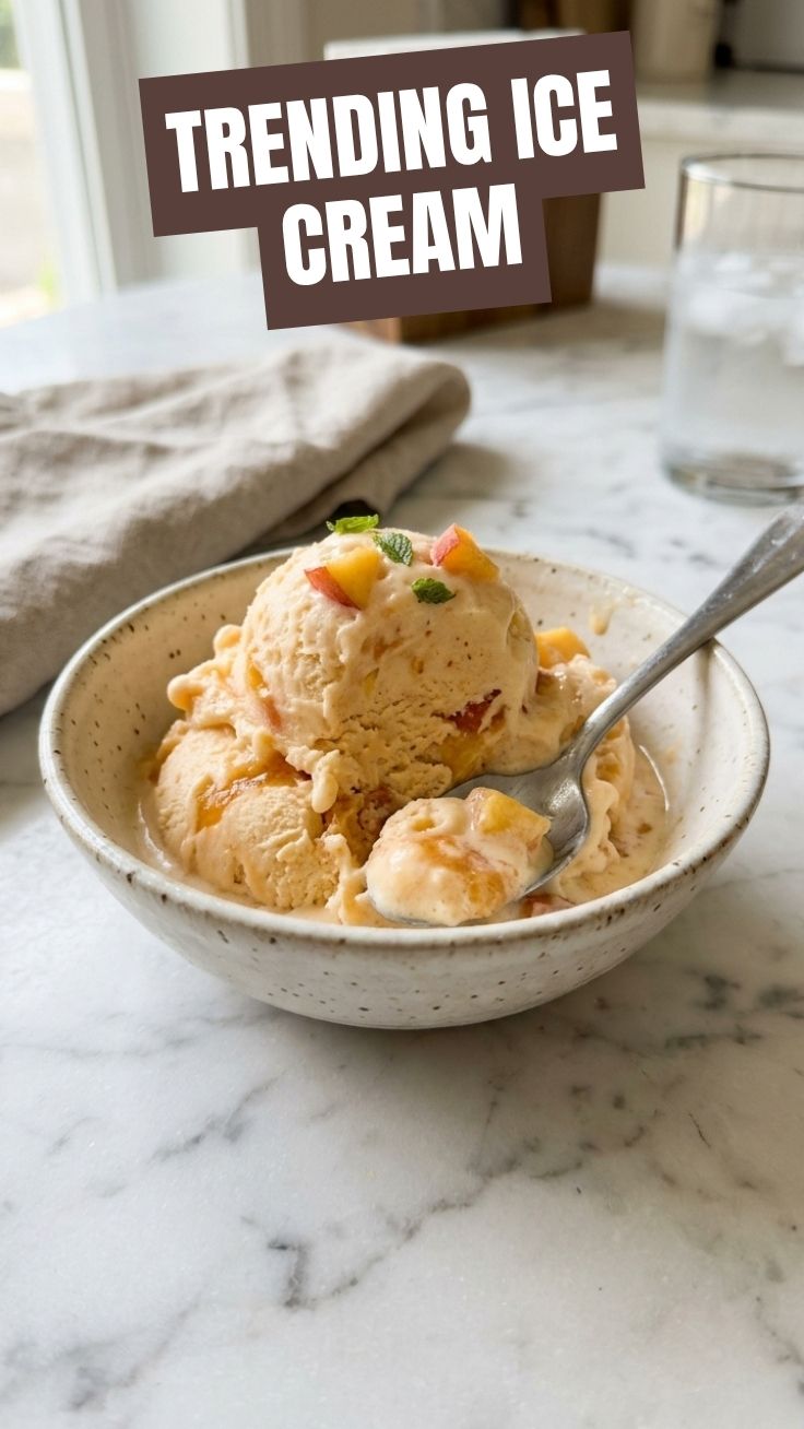 A refreshing scoop of peach ice cream in a bowl